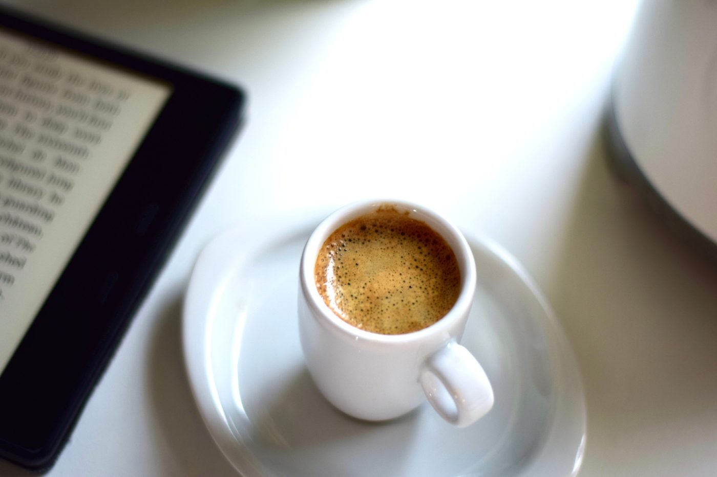 Espresso next to an e-reader